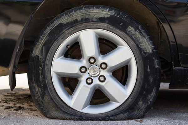 How to Change a Flat Tire Safely on the Side of the Road (Step-by-Step)