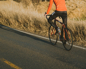Road cyclist riding along a scenic path - cycling tire pressure guide