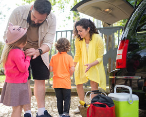 Family preparing car for a road trip with vehicle inspection checklist