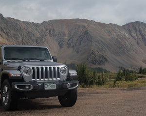 Jeep Wrangler on a rugged Colorado mountain trail during summer 4x4 off-road season