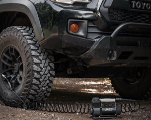 JACO TrailPro portable air compressor inflating off-road truck tire on trail