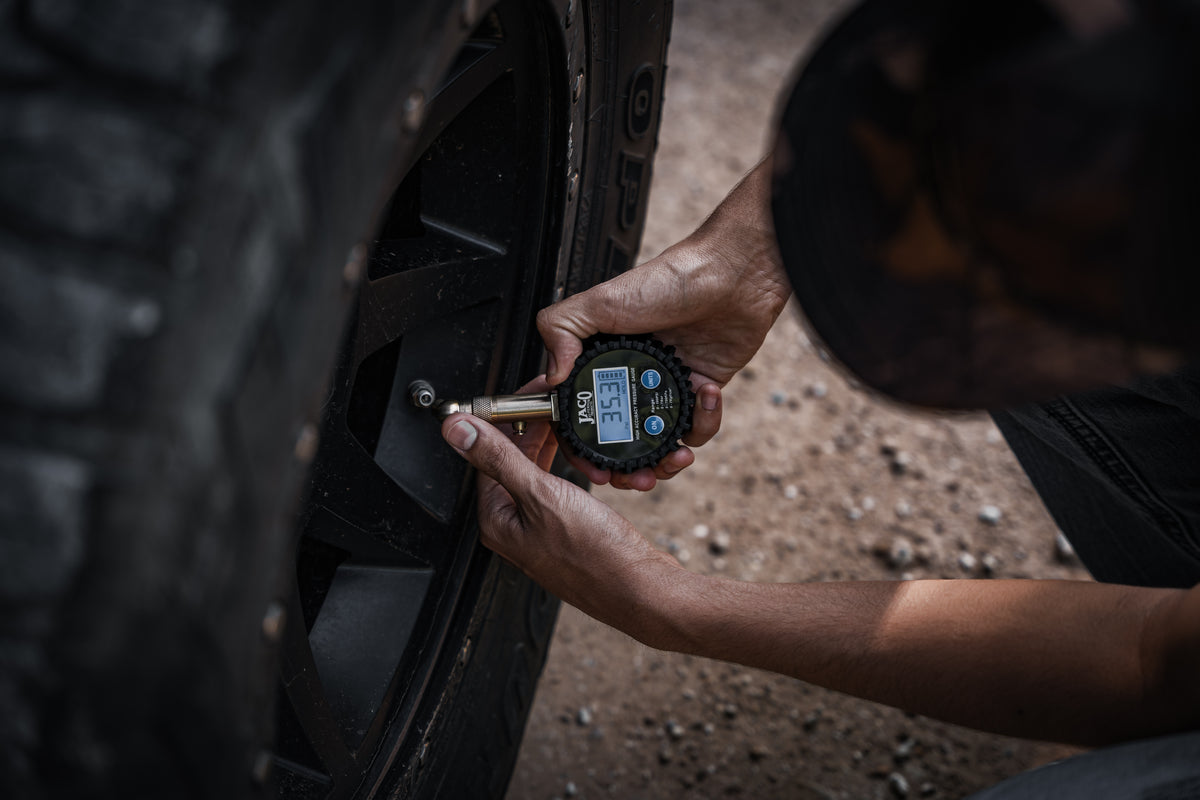 checking tire pressure with digital gauge